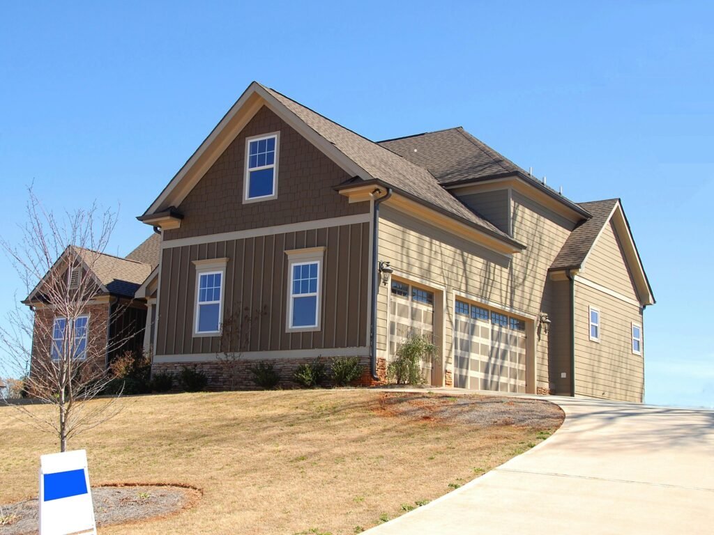 brown house with a brown architectural shingle and vinyl siding