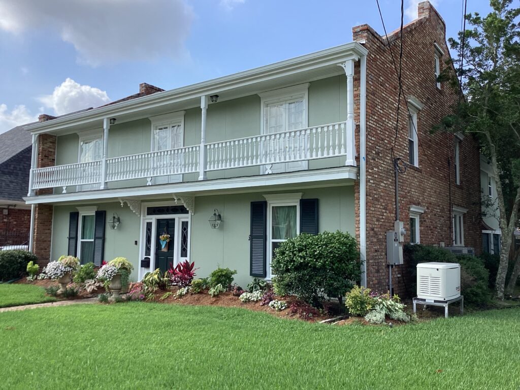 James Hardie Architectural panels remodel with a new stucco look and full gutter installation then fully painted, in Metairie on Folse Drive,