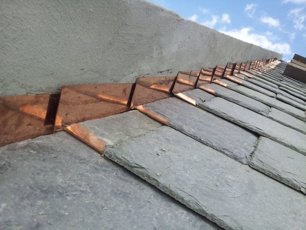 Slate Roof installation and repair of a paraphet wall by Jusaik Roffing and Siding in uptown New Orleans